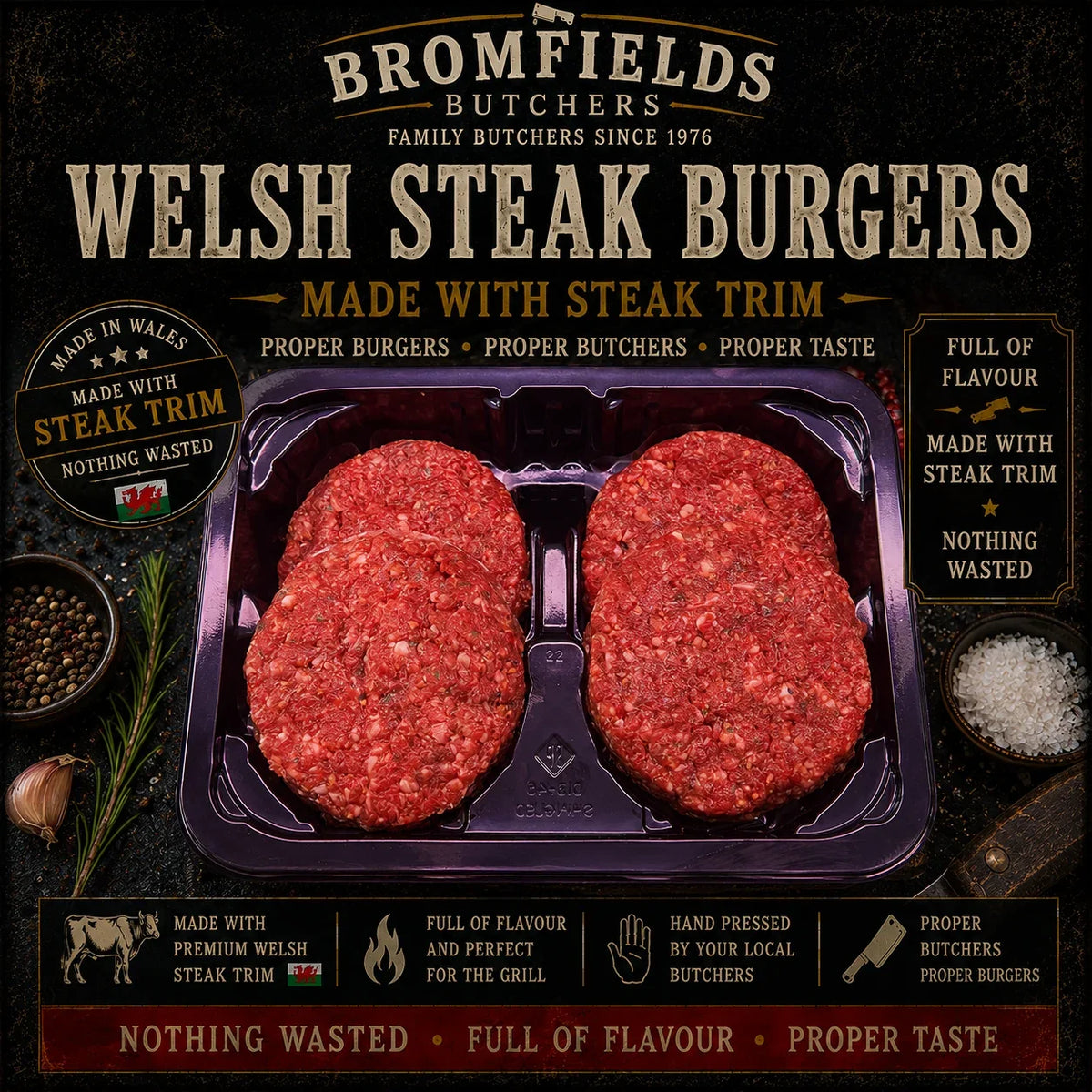 Three Bromfields Burgers Welsh steak burgers in a tray with rosemary, salt, and peppercorns.