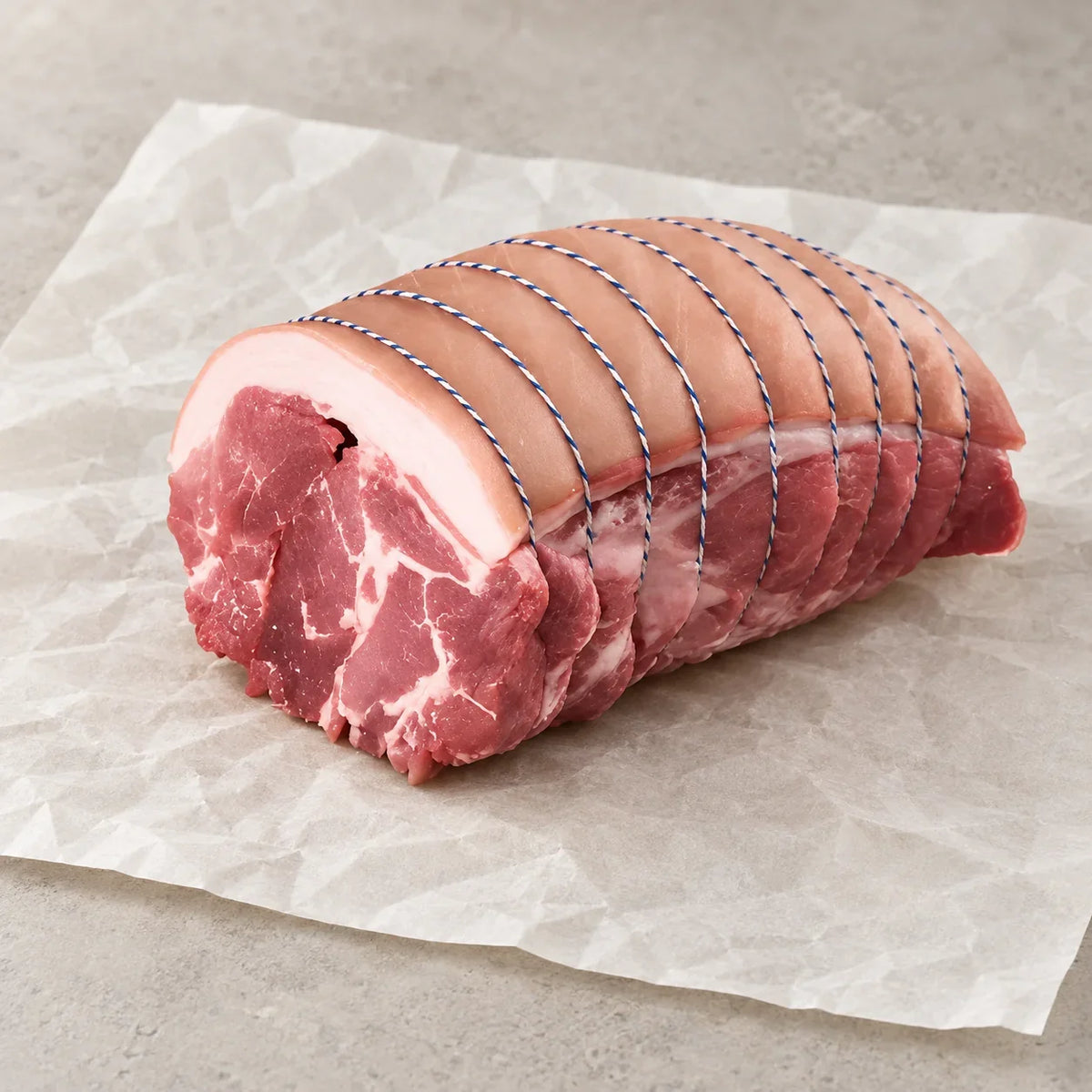 Bromfields Pork boneless pork shoulder tied with butcher's twine on parchment paper