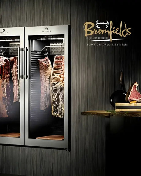 Broomfields Butchers display showcasing high-quality meats hanging in a stylish refrigerator unit.