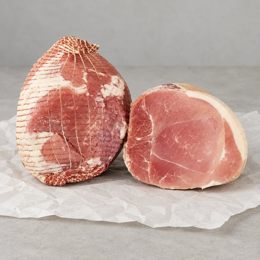 A whole and a sliced Bromfields Gammon Gammon Slipper Joint on white parchment paper.