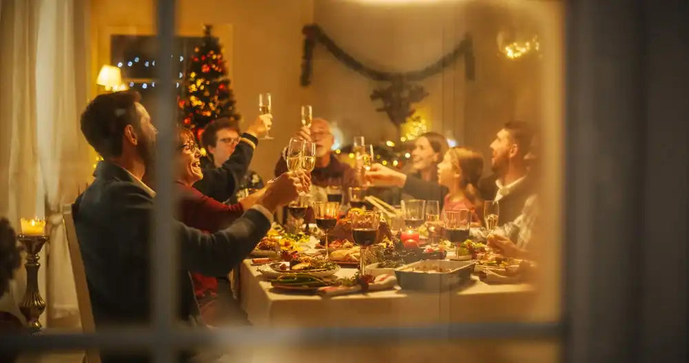 Family gathering around a festive dinner table for a holiday meal.